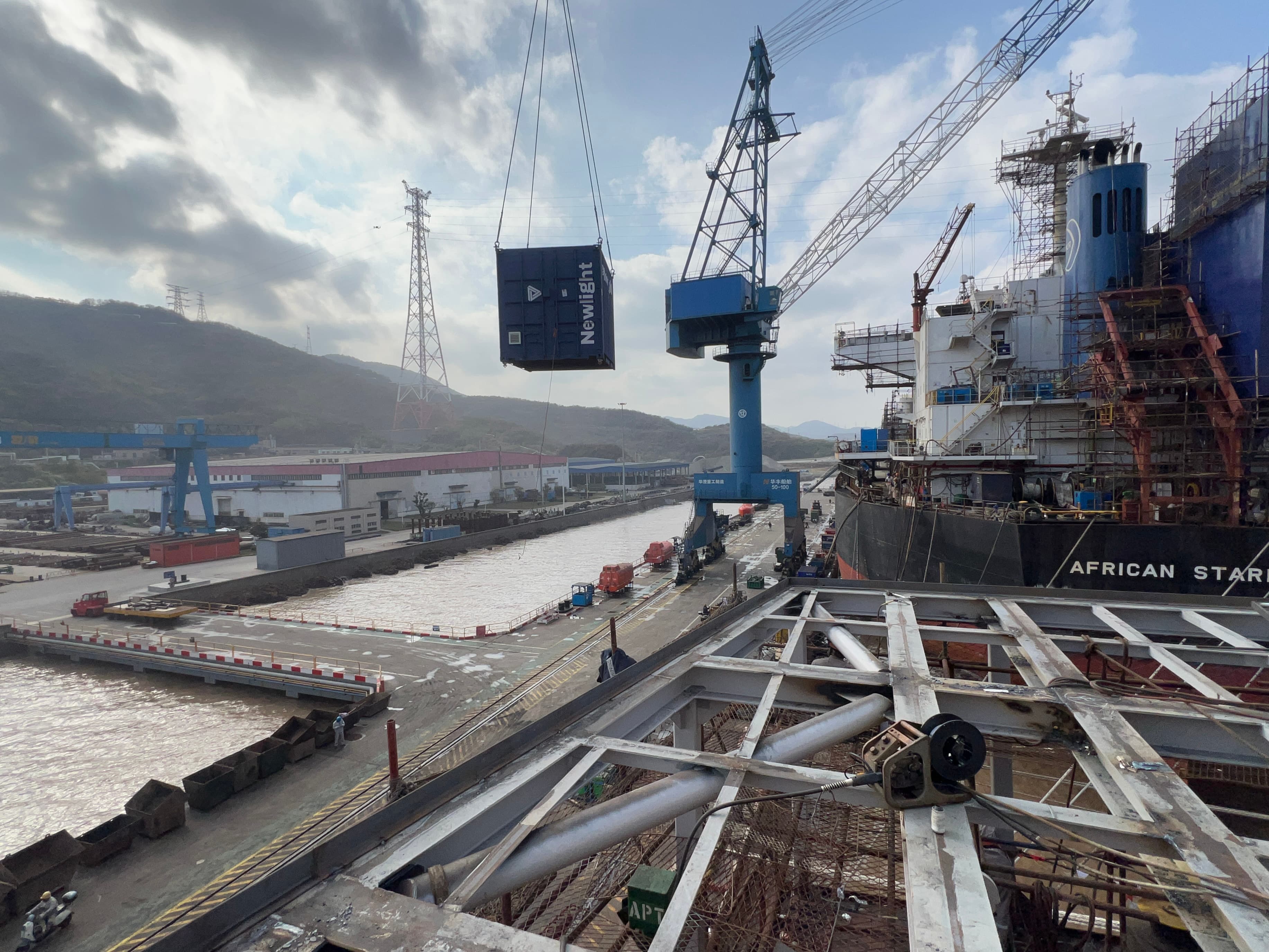 Newlight containerized equipment being lifted during vessel integration